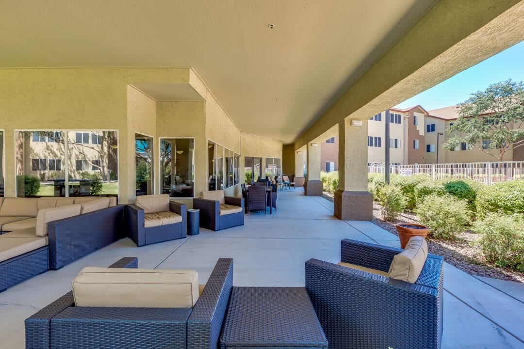 Spacious outdoor patio area with comfortable seating at an apartment complex.