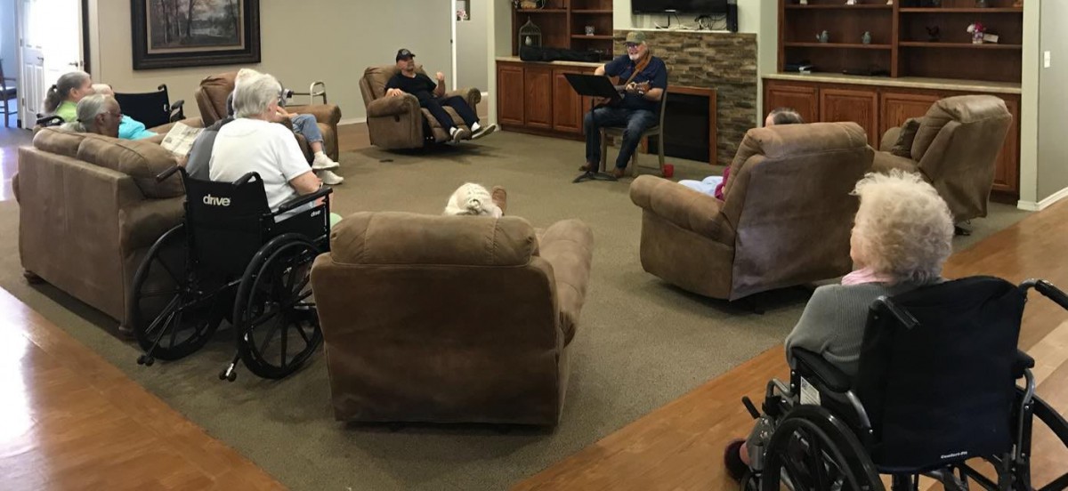 A group of people having a discussion in a cozy, indoor seating area.