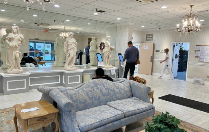 A modern lobby with sculptures and a comfortable waiting area.