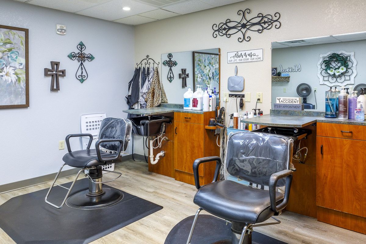 A cozy barbershop interior with styling chairs and mirrors.