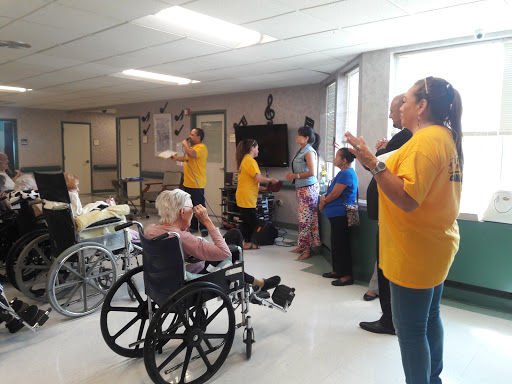 Residents and staff engage in an interactive activity to promote joy and social interaction.