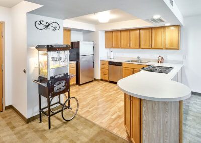 A modern kitchen with wooden cabinets and a popcorn machine.