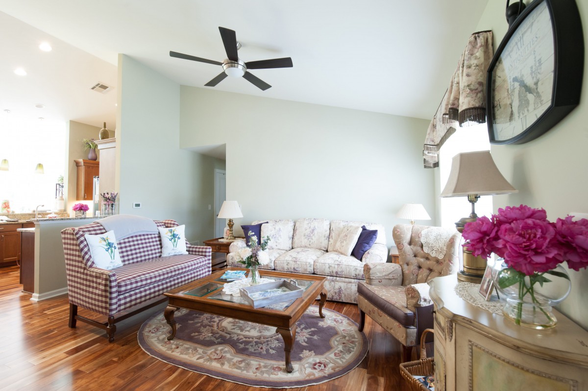A cozy living room with comfortable seating, a coffee table, and elegant decor.