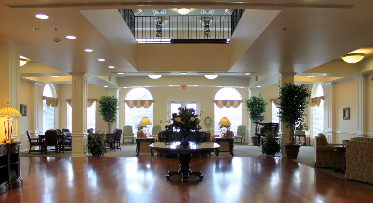 A well-lit hotel lobby with elegant furniture and decor.