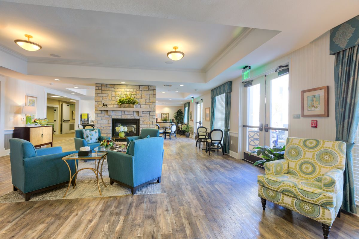 A modern and spacious living room with a cozy seating area and a fireplace.