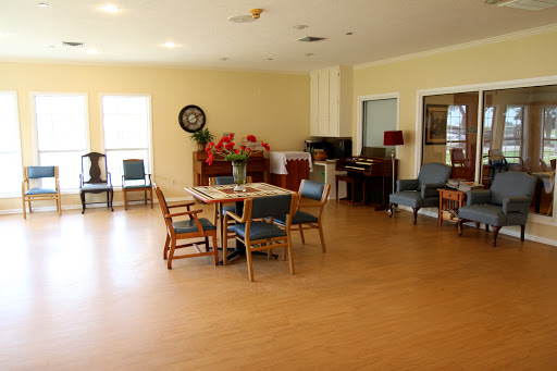 A spacious and well-lit interior featuring a dining area with tables and chairs, suitable for gatherings.