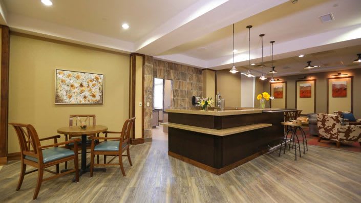 A modern kitchen with an island counter and stylish pendant lights.
