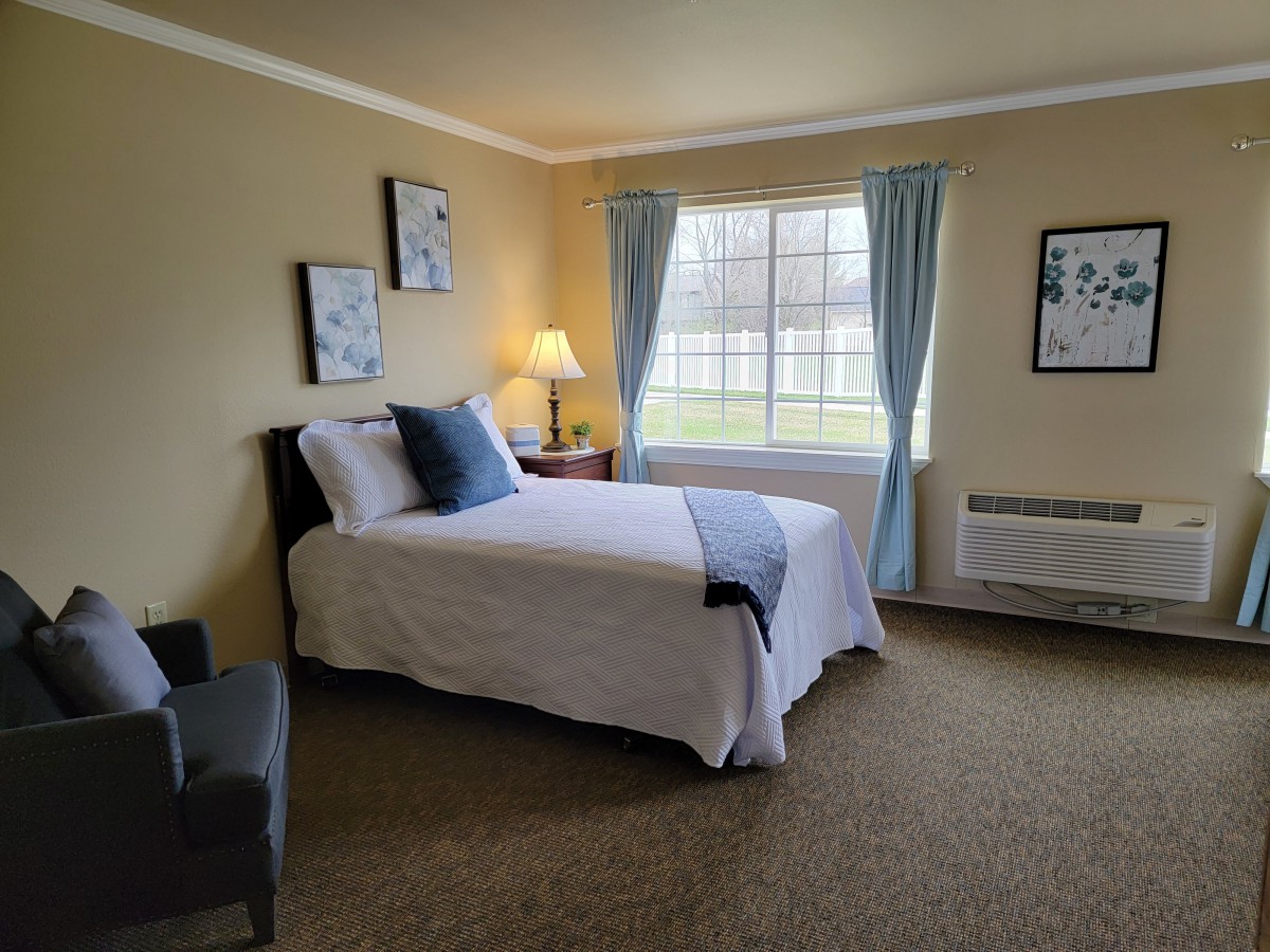 A cozy bedroom with a neatly made bed, soft lighting, and charming decor.