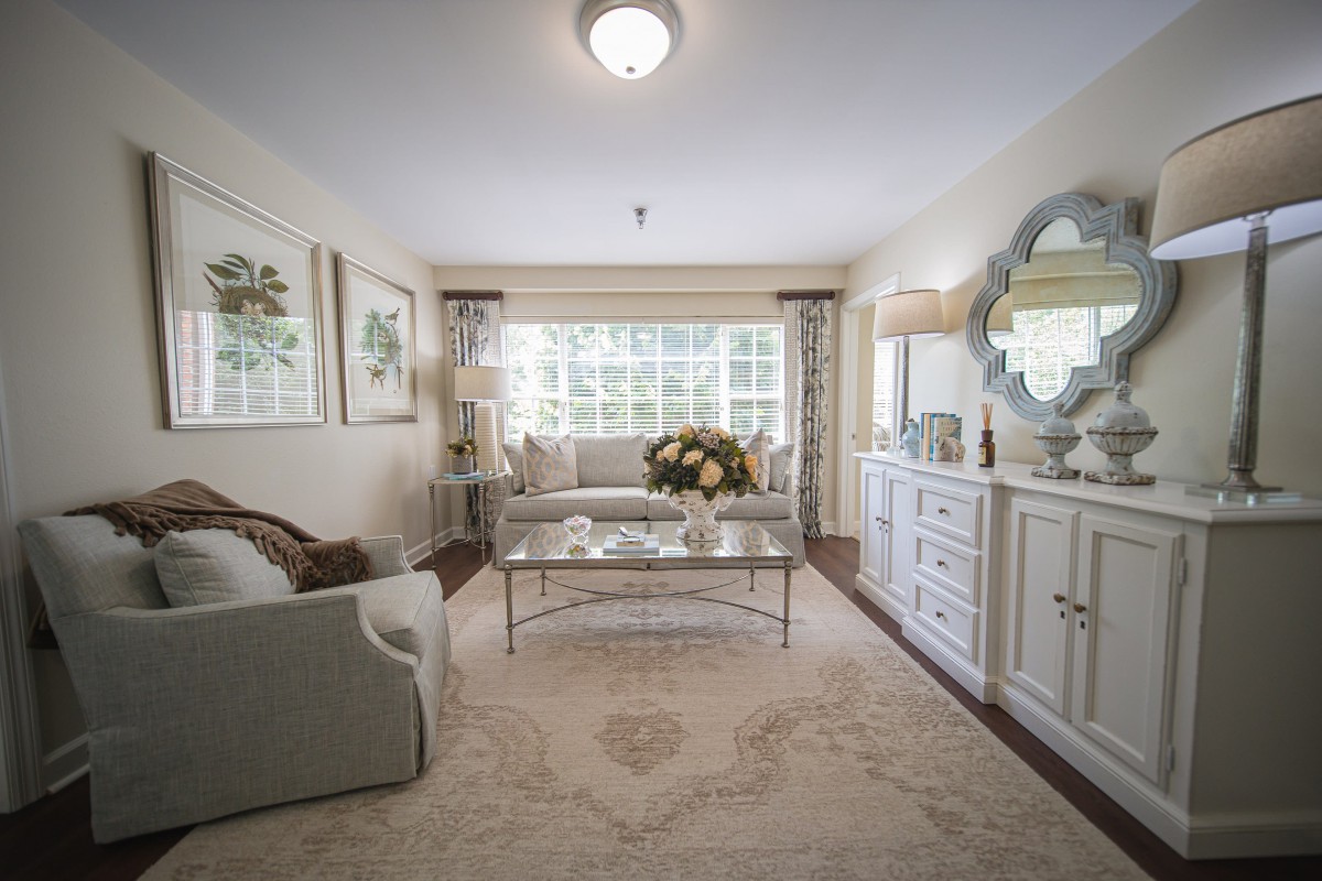 A beautifully decorated living room with elegant furniture and large windows.