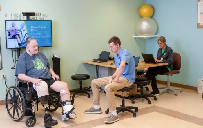 A physical therapy session with a patient and therapist, focusing on rehabilitation exercises.