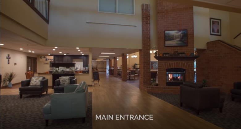 Spacious lobby with a cozy fireplace and modern decor.