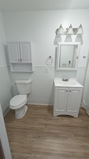 A clean and modern bathroom featuring white fixtures and minimalistic design.
