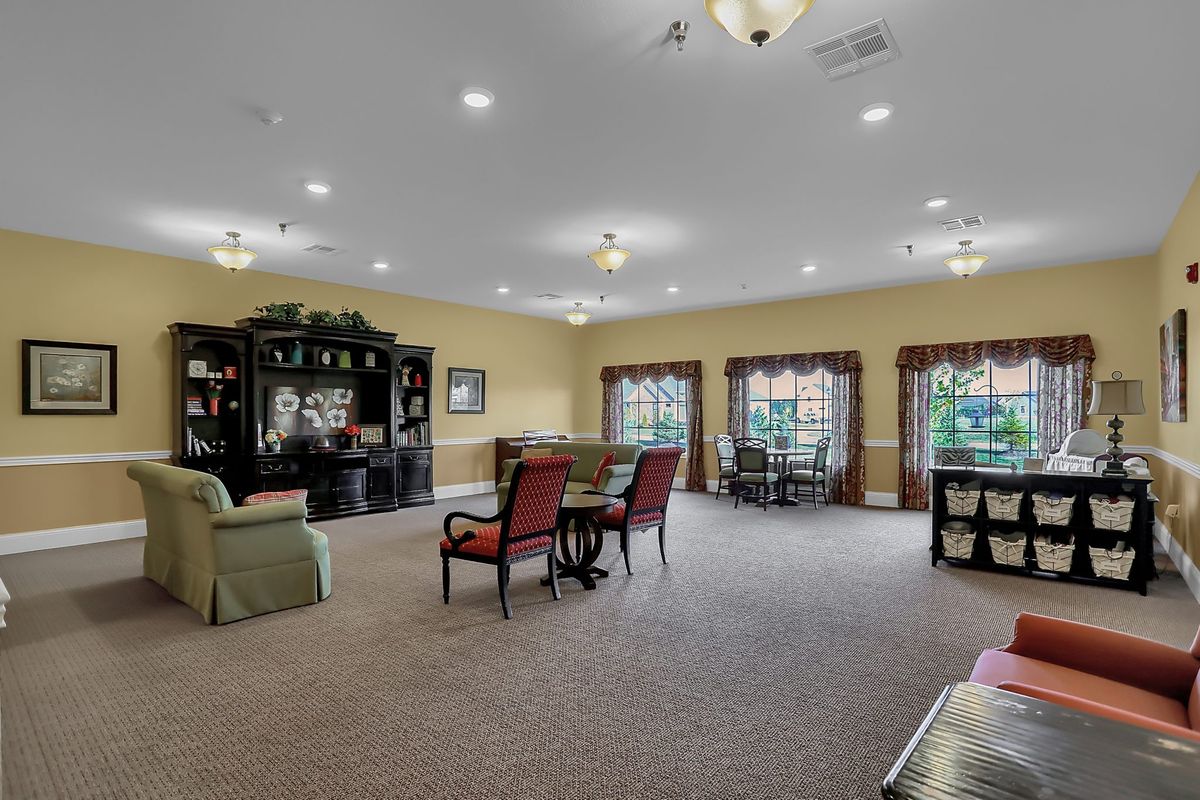 A spacious living room with elegant furniture and ample natural light.