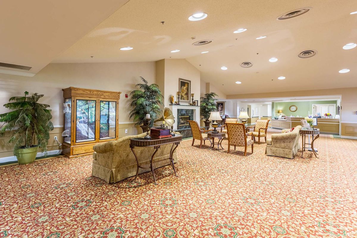 A spacious and warmly decorated lobby with comfortable seating arrangements.
