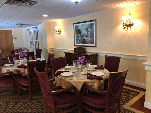 A beautifully arranged dining room with elegant table settings and floral centerpieces.