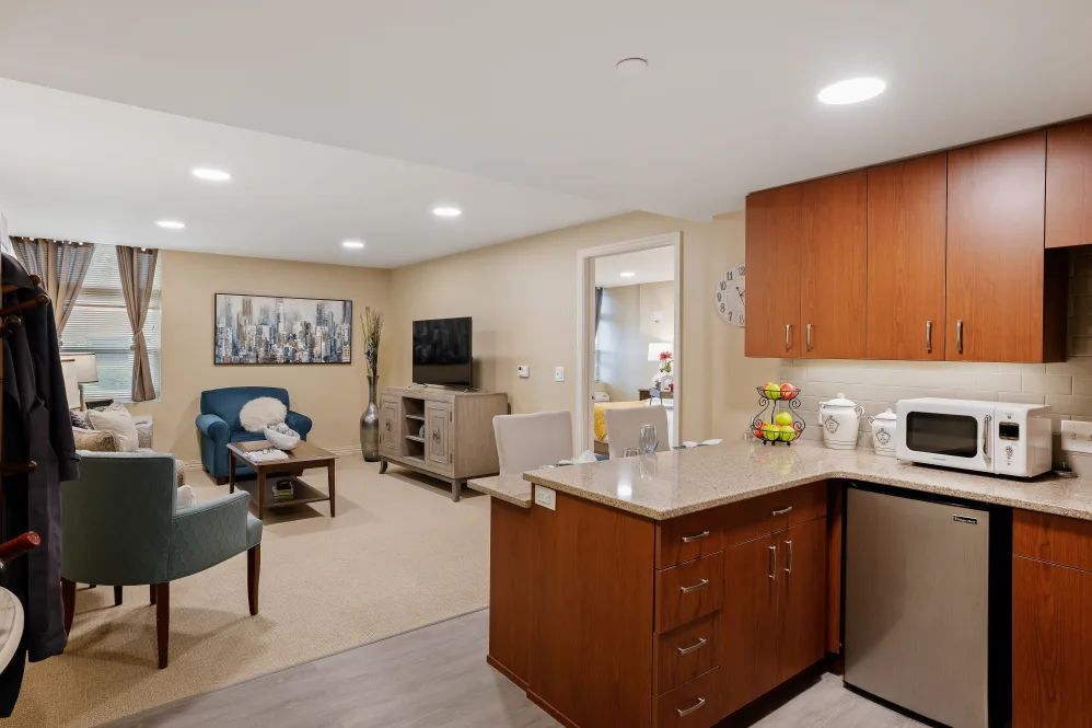 A modern open-concept living area with a kitchen and comfortable seating.