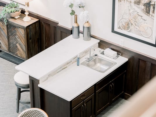 A modern kitchen island with a sink and sleek countertop.