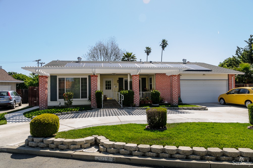 A suburban house with a well-maintained front yard and landscaping.