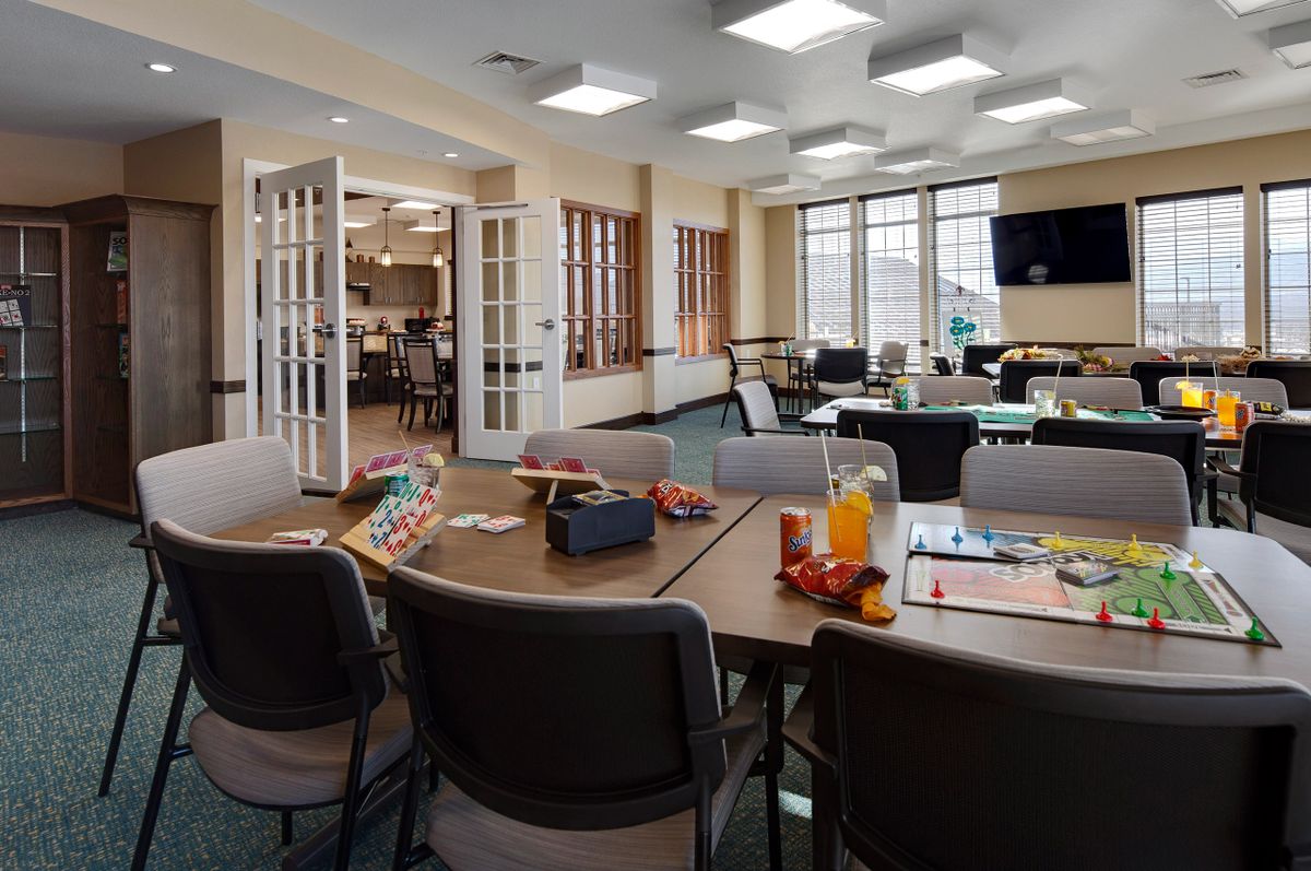 Spacious conference room set up with tables, chairs, and refreshments.