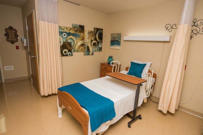 A well-organized hospital room with a neatly made bed and modern decor.