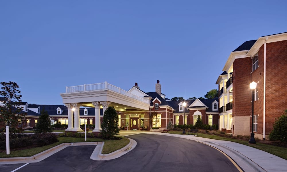 Elegant building entrance illuminated at night.