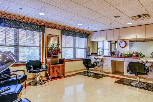 A well-lit salon interior featuring styling chairs, mirrors, and a cozy waiting area.