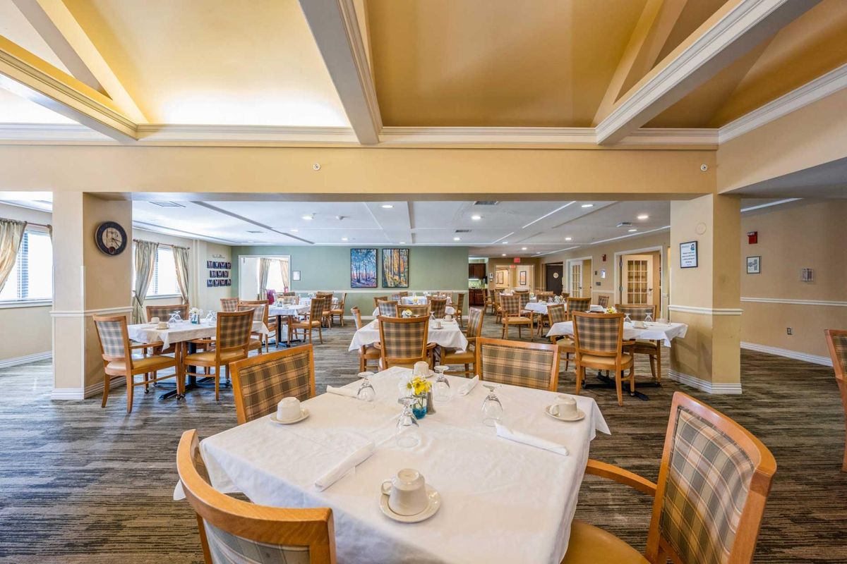 An elegantly arranged dining area with neatly set tables and chairs.