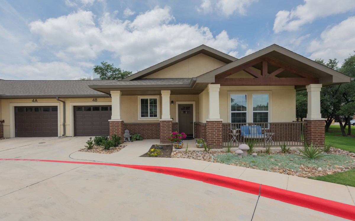 A modern residential home with a front porch and attached garage.