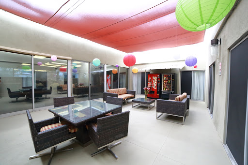 A modern lounge area with comfortable seating and colorful decorative elements.