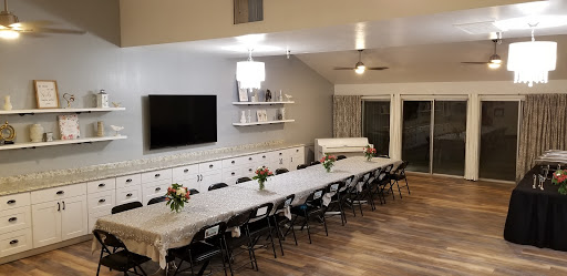 A spacious dining area set with a long table and elegant floral arrangements, perfect for gatherings.