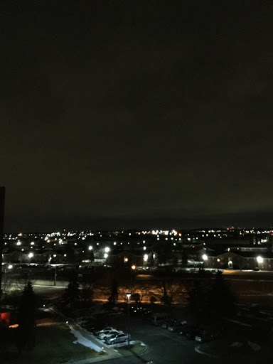 A serene night view of a city illuminated by lights against a dark sky.