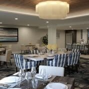 A stylish restaurant dining area with elegant furniture and table settings.