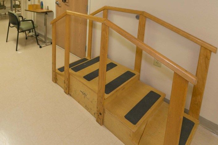Wooden indoor stairs with handrails, possibly used for exercise or rehabilitation.