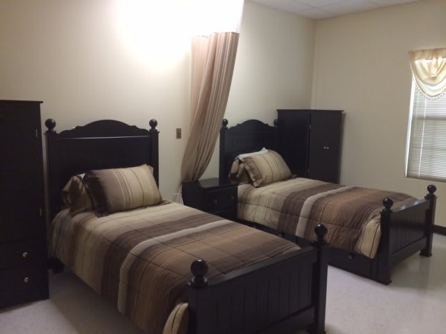 A cozy bedroom with twin beds and a warm color palette.