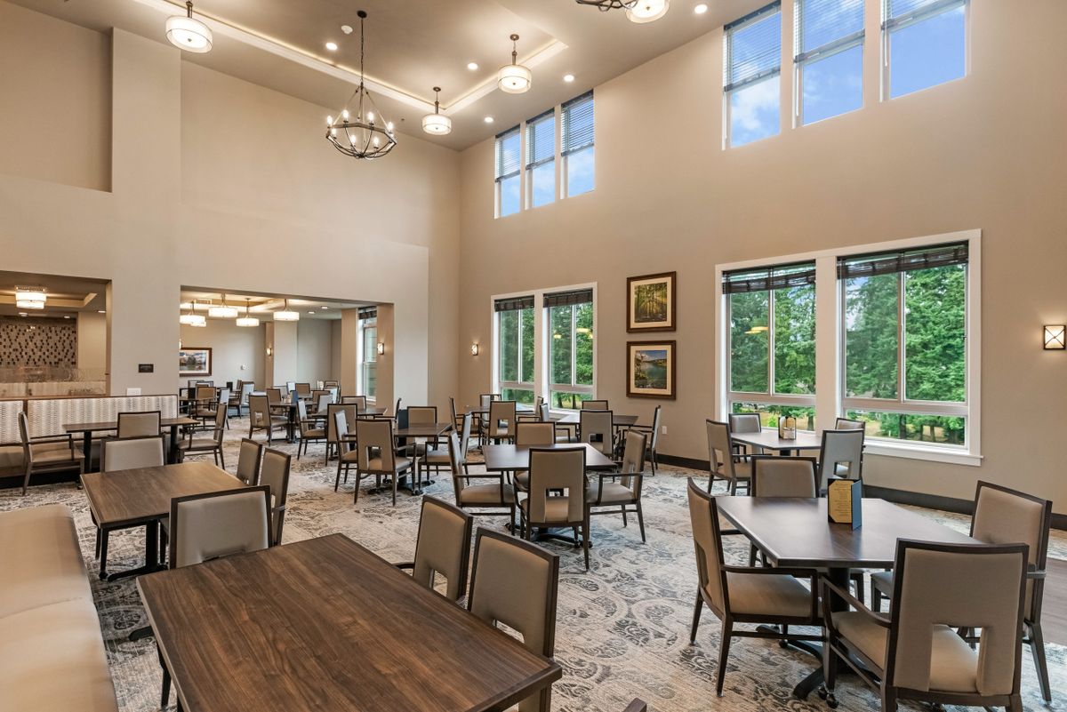 Spacious dining room with elegant decor and large windows.
