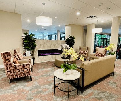 A modern lobby with comfortable seating, a fireplace, and elegant decor.