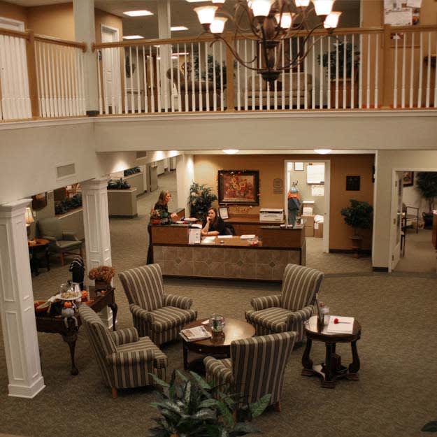 Elegant two-story lobby with seating area and reception desk.