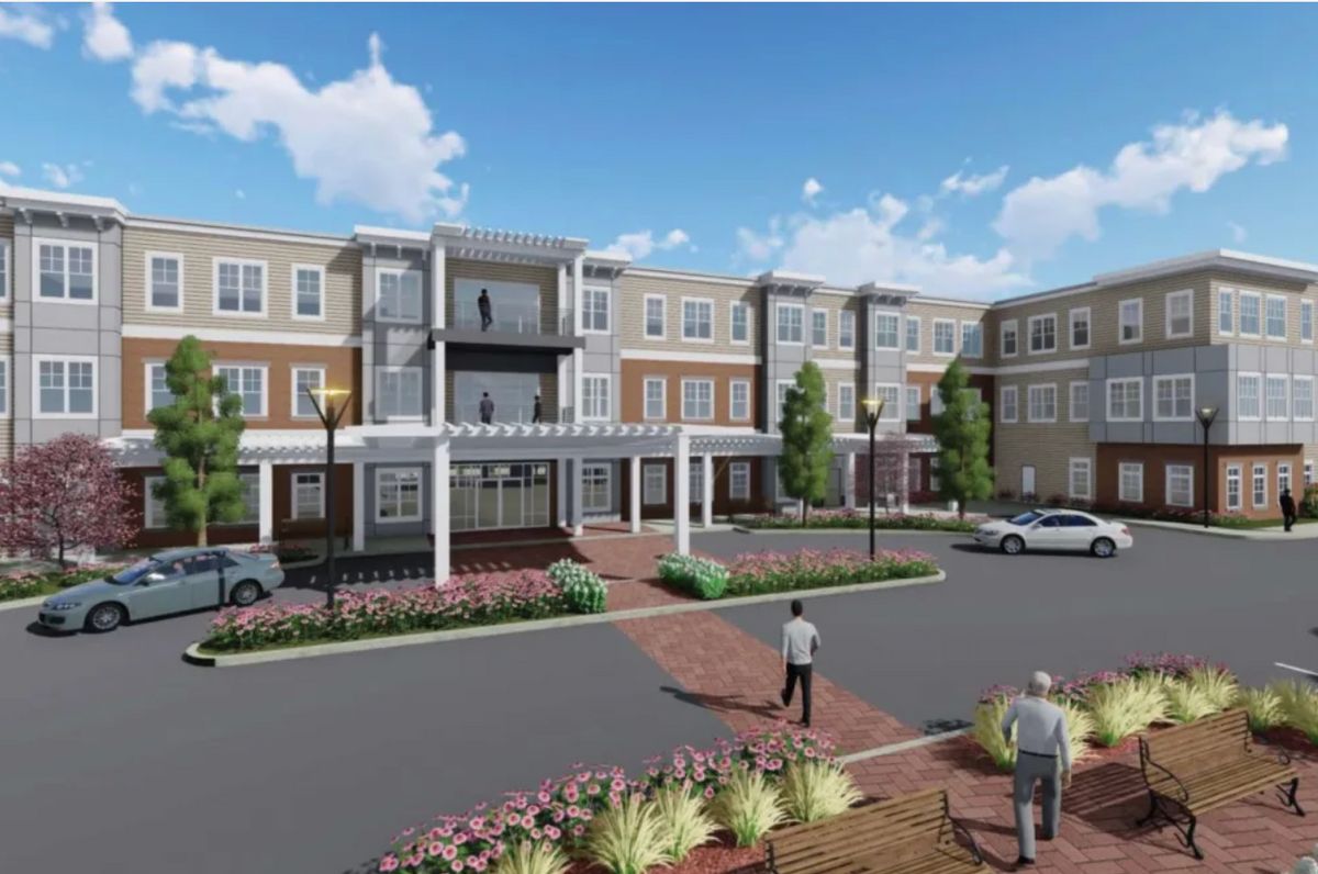 A modern residential complex with well-maintained landscaping and a spacious parking area.