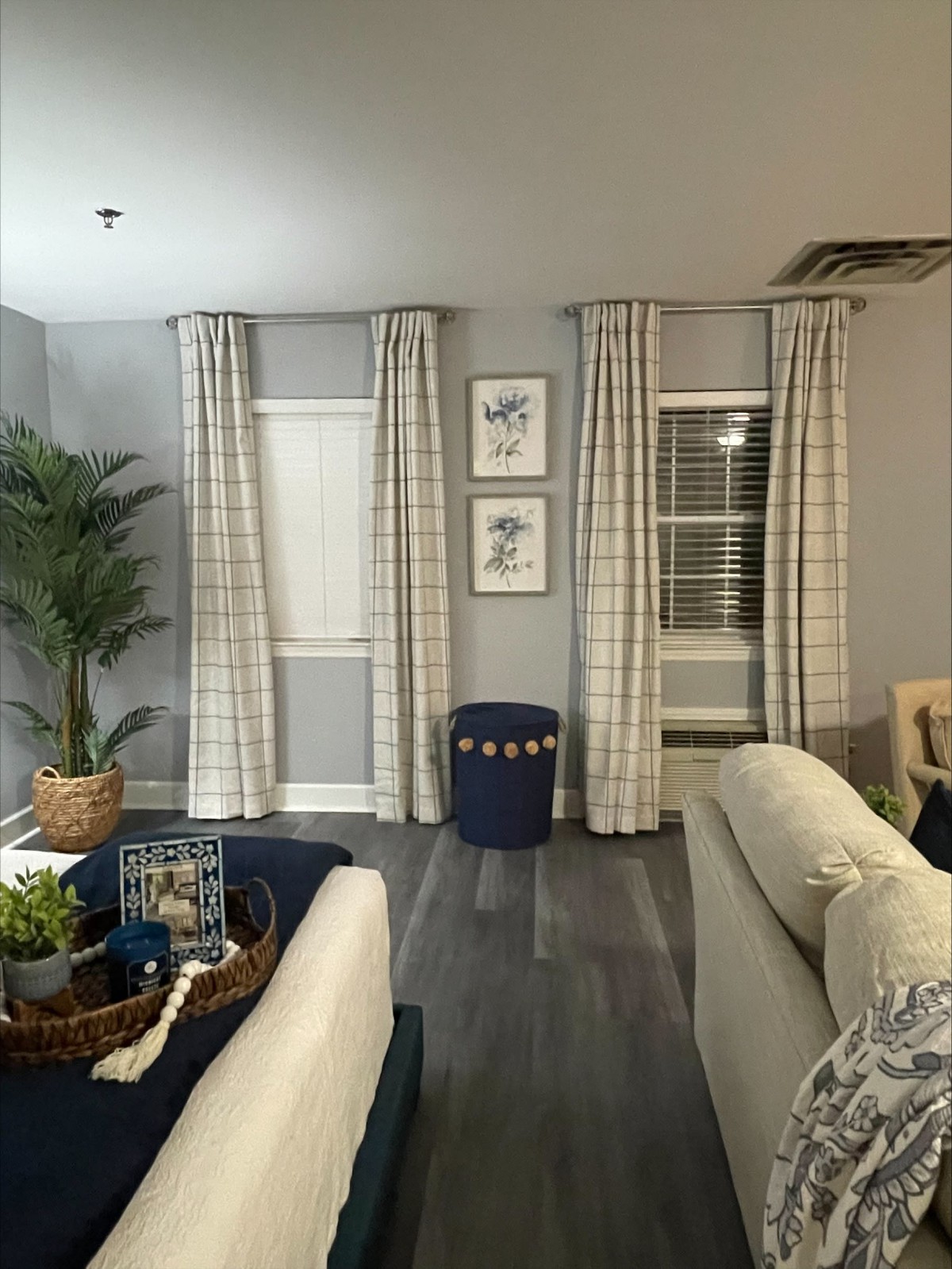A cozy living room with checkered curtains and modern decor.