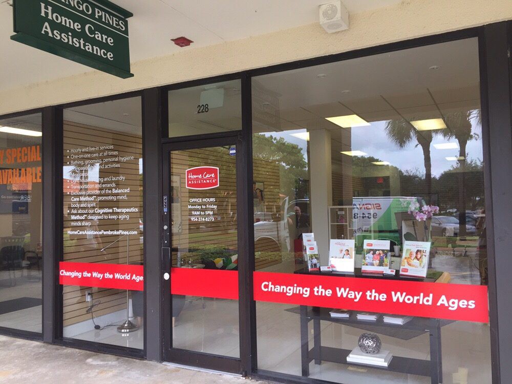A storefront of a business with glass doors, displaying signage and items in the window.