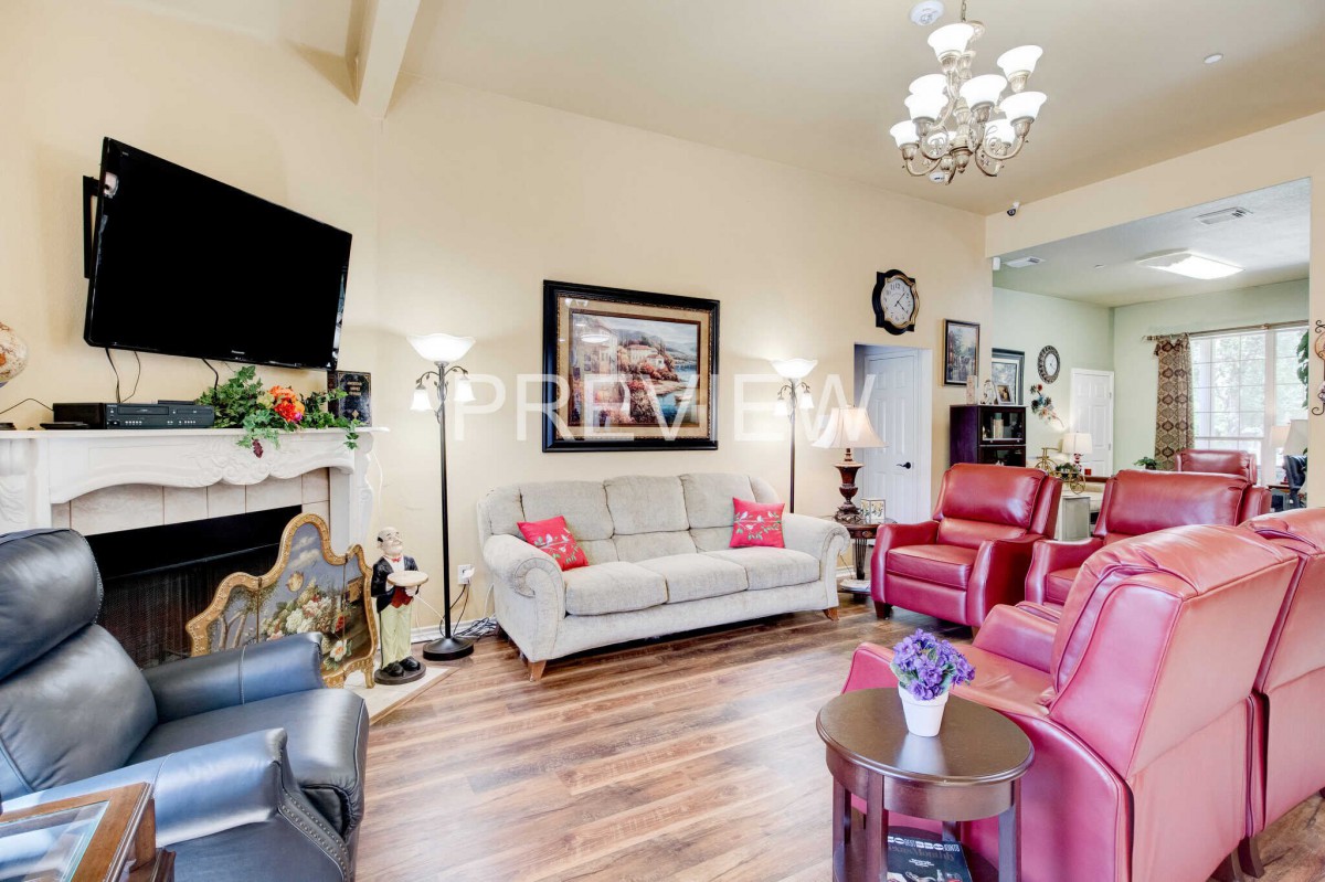 A cozy living room with comfortable seating, a mounted television, and elegant decor.