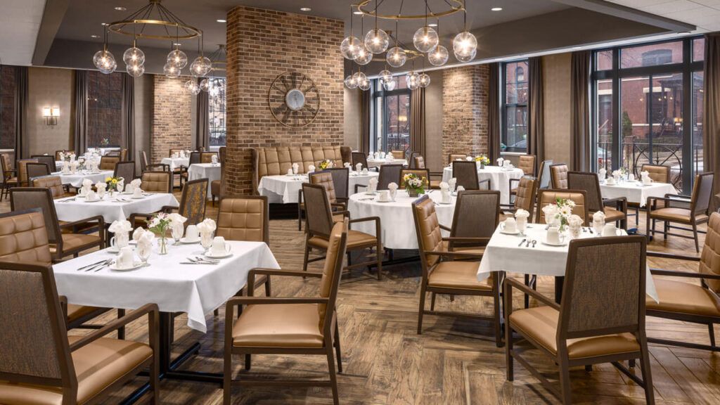 A stylish restaurant dining area with neatly arranged tables and decorative lighting.