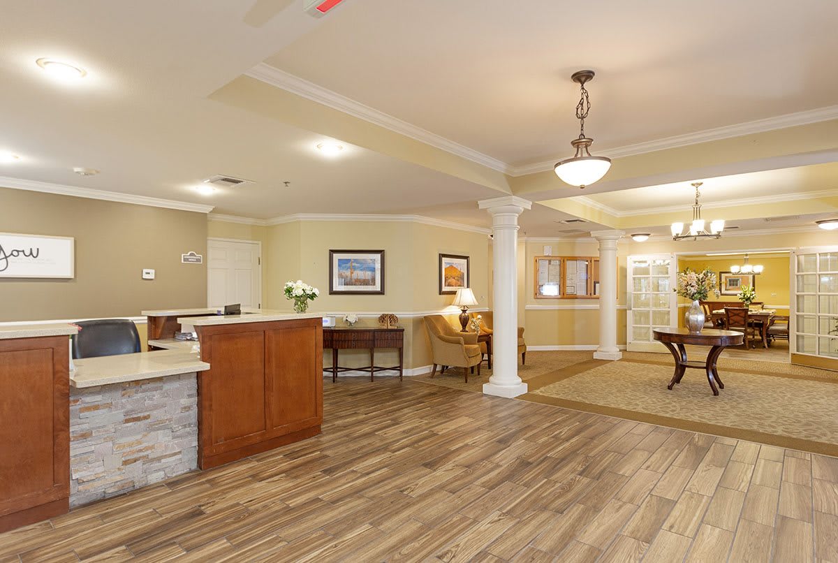 A bright and inviting reception area with wood flooring and elegant lighting fixtures.