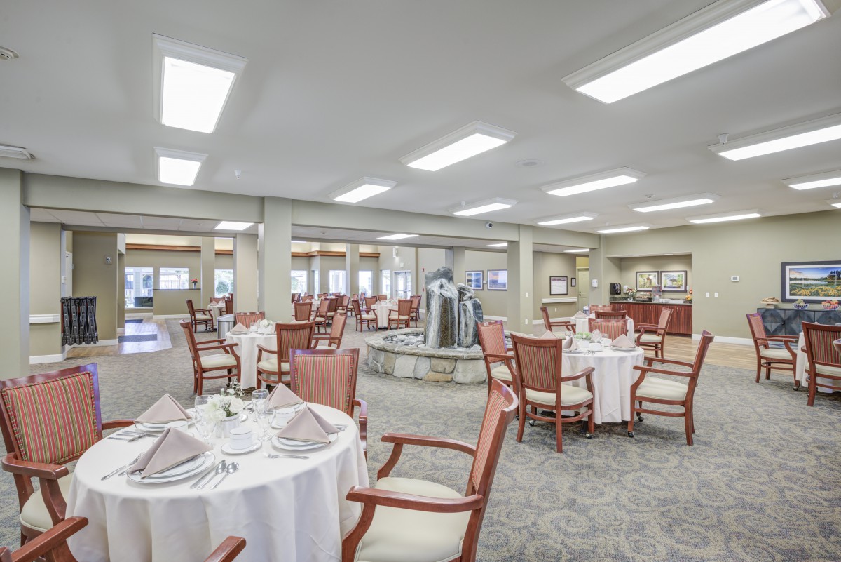 Elegant dining area with neatly arranged tables and chairs in a well-lit setting.