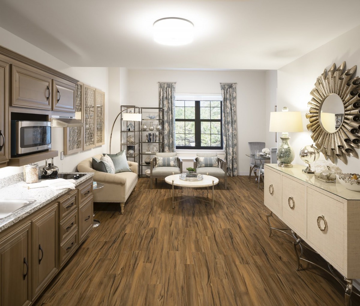 A cozy and modern living room with wood flooring, stylish furniture, and elegant decor.