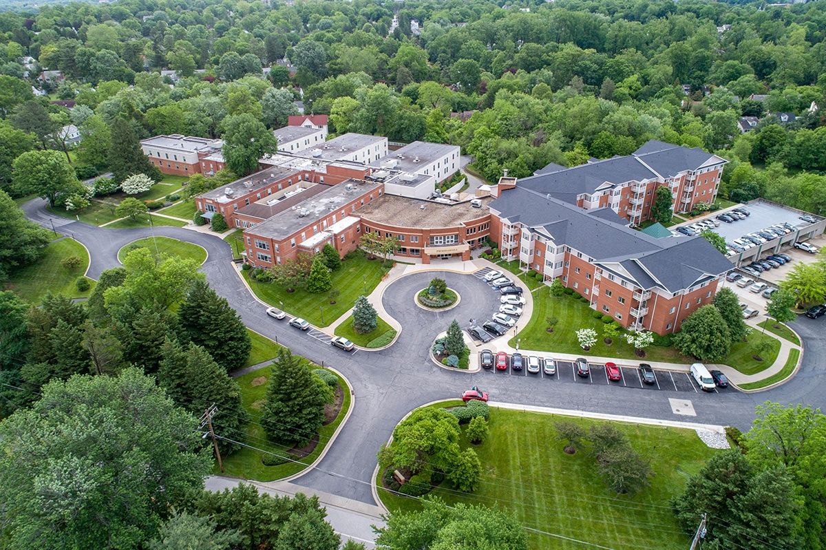 Aerial view of a large building complex surrounded by greenery.