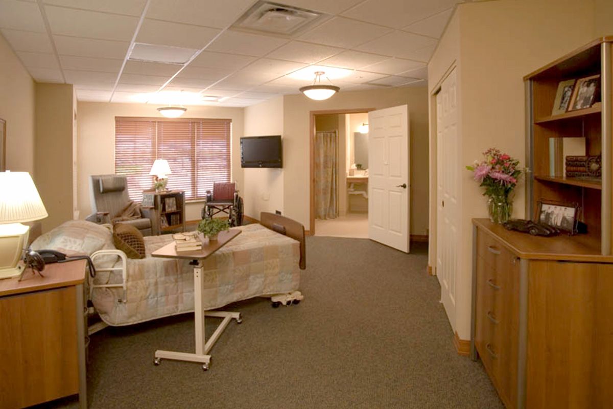 A cozy hospital room equipped with a bed, television, and patient amenities.