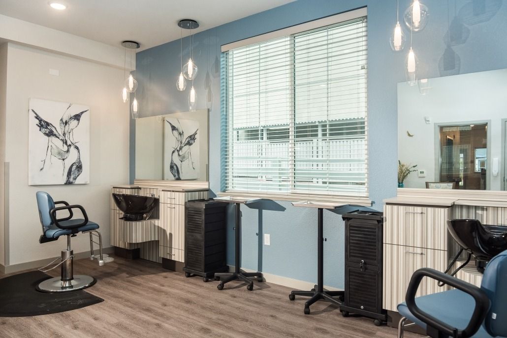 A modern hair salon with styling stations and contemporary decor.