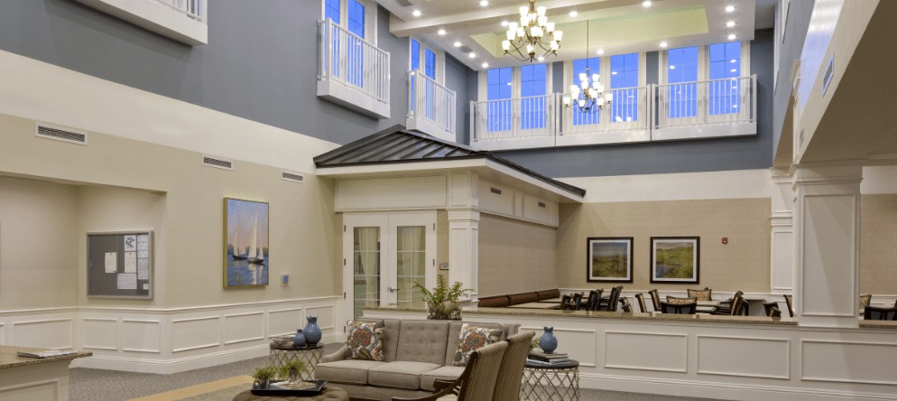 A luxurious lobby with modern furnishings, high ceilings, and elegant chandeliers.