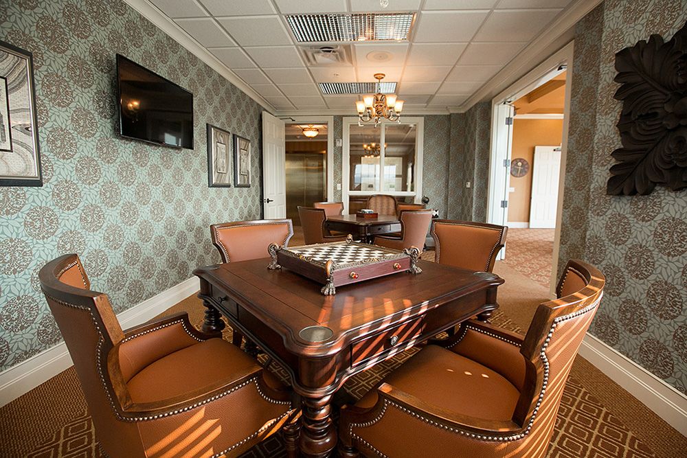A luxurious dining room with elegant furniture and a chandelier.